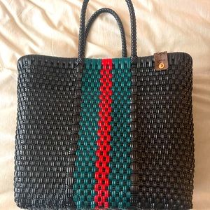 Handmade woven tote made out of recycled plastic.
